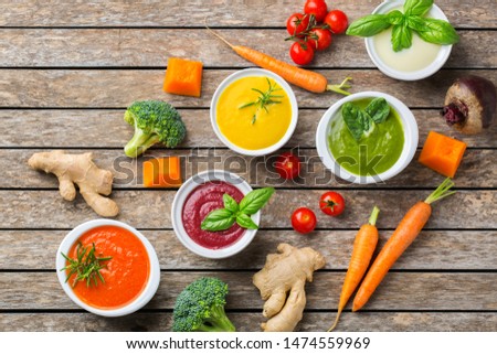 Healthy food, clean eating concept. Variety of colorful seasonal fall vegetables creamy soups with ingredients. Pumpkin, broccoli, carrot, beetroot, potato, tomato spinach. Flat lay
