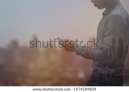 businessman using mobile on abstract city background with copy space. Communication concept. Double exposure