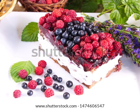 Cake with cream and fresh raspberries and blueberries delicious healthy dessert