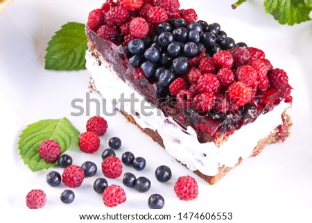 Cake with cream and fresh raspberries and blueberries delicious healthy dessert