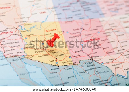 Red clerical needle on a map of the USA, Arizona and the capital Phoenix. Close up map of orizona with red tack