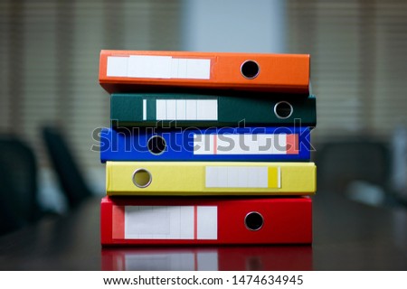 a stack of folders on the table and copy space close up