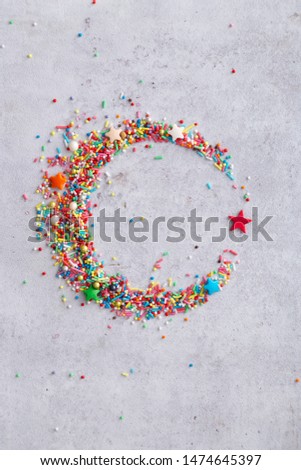 Sweet Islam symbol - star and crescent made of colorful sprinkles. Top view