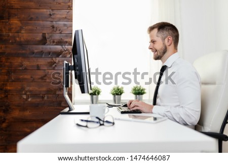 Successful handsome businessman working in his office