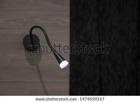 Modern wall lamp on the wooden wall