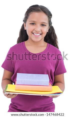 Little girl holding notebooks and books for her homework in white background