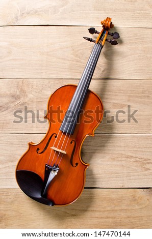 a violin on wooden background