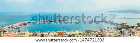 Industrial port or harbor with container or cargo ships and cranes in iskenderun seaport at Hatay city of Turkey. Transportation and logistic at Mediterranean sea.  Royalty-Free Stock Photo #1474721303