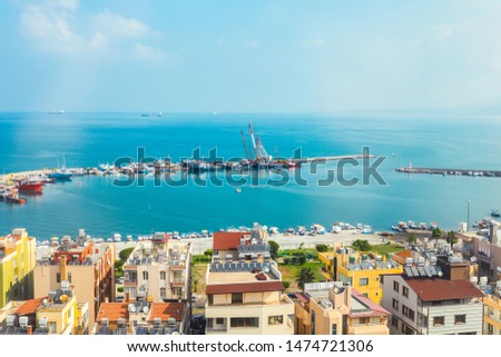 Industrial port or harbor with container or cargo ships and cranes in iskenderun seaport at Hatay city of Turkey. Transportation and logistic at Mediterranean sea.  Royalty-Free Stock Photo #1474721306