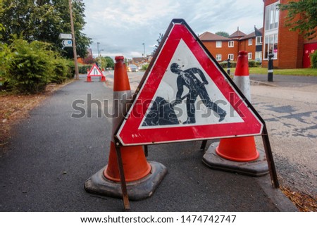 Road signs warning motorists and pedestrians or roadworks further down the road