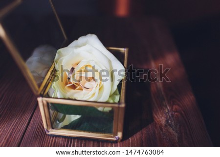 wedding rings in the box and a bouquet of the bride on the table.