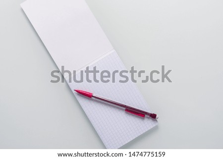 Top view of blank notebook with pencil on white background with copy space