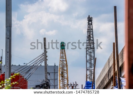 crane in construction area 
has a blue sky as the background.