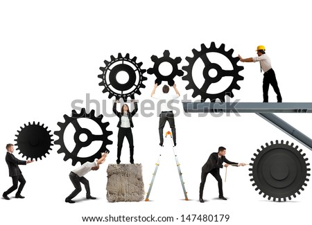Teamwork works together to build a gear system Royalty-Free Stock Photo #147480179
