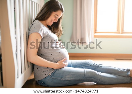 A Beautiful Pregnant mother on baby room