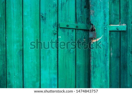 Green wooden background texture with padlock. Vertical planks, bars
