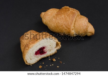 French croissants on black background with copyspace.