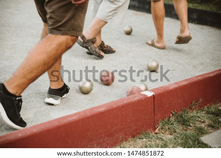 Friends play bowling in the park