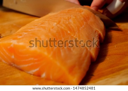 slicing red fish on the board. Pieces of red fish.