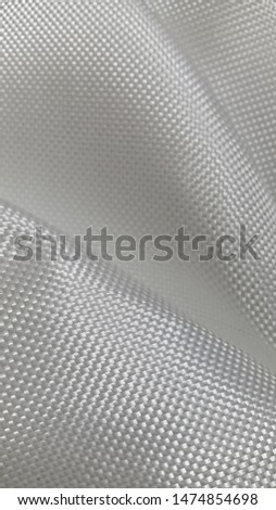 Fiberglass fabric. Abstract background. Fiberglass. Woven texture. Textured surface. Glass threads. Light fabric