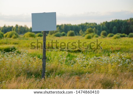 Sign on the nature near the forest on a sunny day