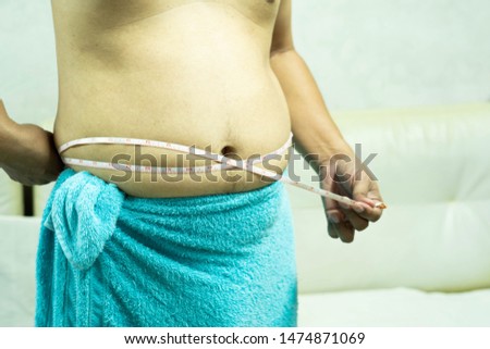 Fat man with a big belly. Diet concept.focus around front of picture- Image.
