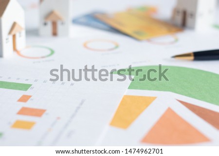 Property investment, Miniature white houses with credit cards and  financial documents on table
