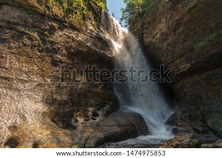 beautiful HDR picture of powerful waterfall in forest near Munising , MI , USA , 2019