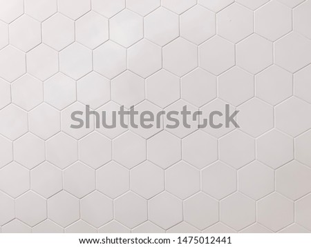 real photo of white hexagonal tiles wall  of the bathroom