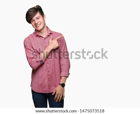 Young handsome business man over isolated background cheerful with a smile of face pointing with hand and finger up to the side with happy and natural expression on face
