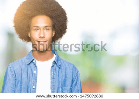 Young african american man with afro hair Hands together and fingers crossed smiling relaxed and cheerful. Success and optimistic
