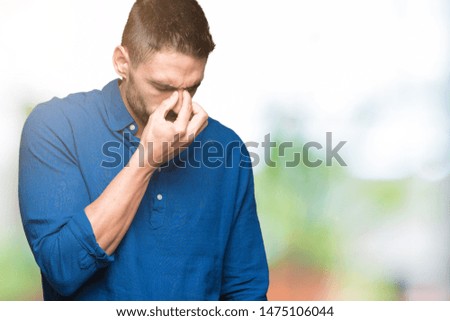 Young handsome man over isolated background tired rubbing nose and eyes feeling fatigue and headache. Stress and frustration concept.