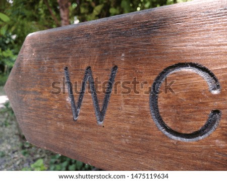 An old wooden wc signboard