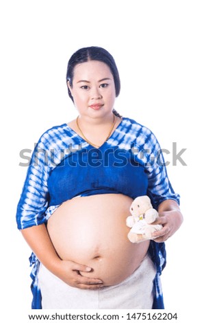 Pregnant woman with teddy bear isolated on white