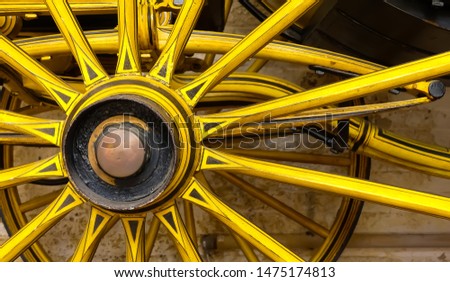 Close up of a liveried mid Victorian (1865) horse drawn carriage, showing wheels spokes, hub and suspension. Landscape image with space for copy. England.