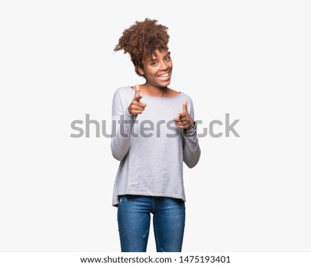 Beautiful young african american woman over isolated background pointing fingers to camera with happy and funny face. Good energy and vibes.