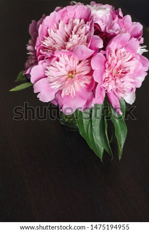 Bouquet of pink peonies flowers on a black wooden table. Copy space.
The bride's bouquet