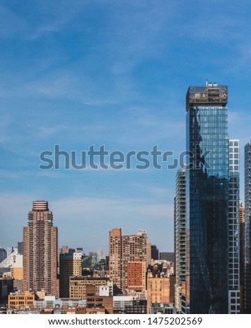 Skyscrapers and buildings of midtown manhattan under blue sky, viewed from Hudson Yard, in New York City, USA