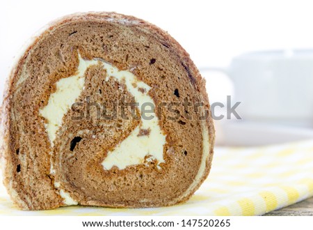 Chocolate roll and coffee cup on white background