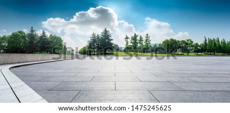 Empty square floor and green woods natural scenery in city park Royalty-Free Stock Photo #1475245625