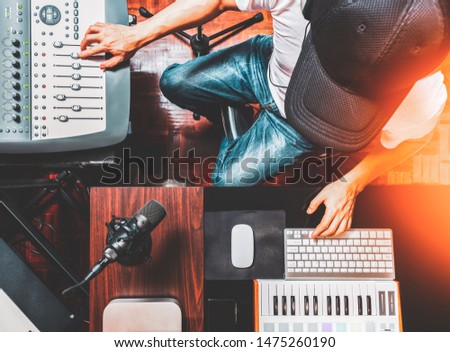 top view of male DJ, producer, composer enjoy mixing music in home recording studio. music production, broadcasting concept Royalty-Free Stock Photo #1475260190