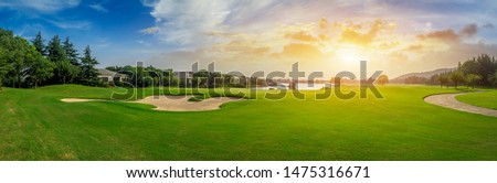 Green grass and woods on a golf field Royalty-Free Stock Photo #1475316671