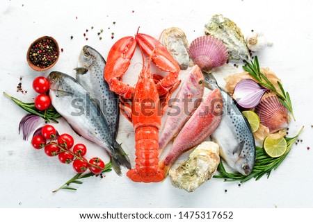 Seafood on a white background. Lobster, fish, shellfish. Top view. Free copy space. Royalty-Free Stock Photo #1475317652
