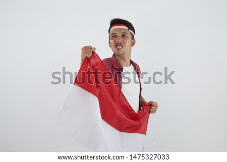 Asian man holding a Indonesian red and white flags with white background  