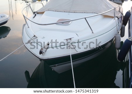 white and blue yacht mooring in the bay