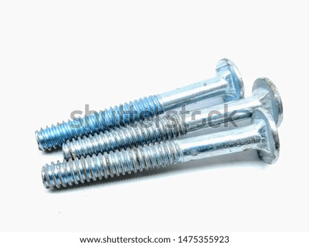 A picture of three stainless steel screws on white background