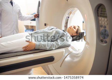 Doctor performing computed tomography test stock photo Royalty-Free Stock Photo #1475358974