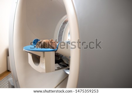 Lady getting CT scan procedure at radiology clinic stock photo