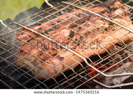 grilled beef ribs smoked on the grill. cooking meat. The meat on the coals. The fried crust on the meat ribs