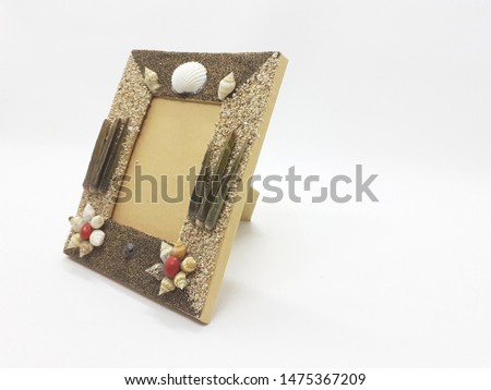 Brown Colorful Classic Modern Unique Stylish Empty Photo Frame in Background for Home Interior and Garden Furniture made from Wood and Sea Shells Accessories in white Isolated Background